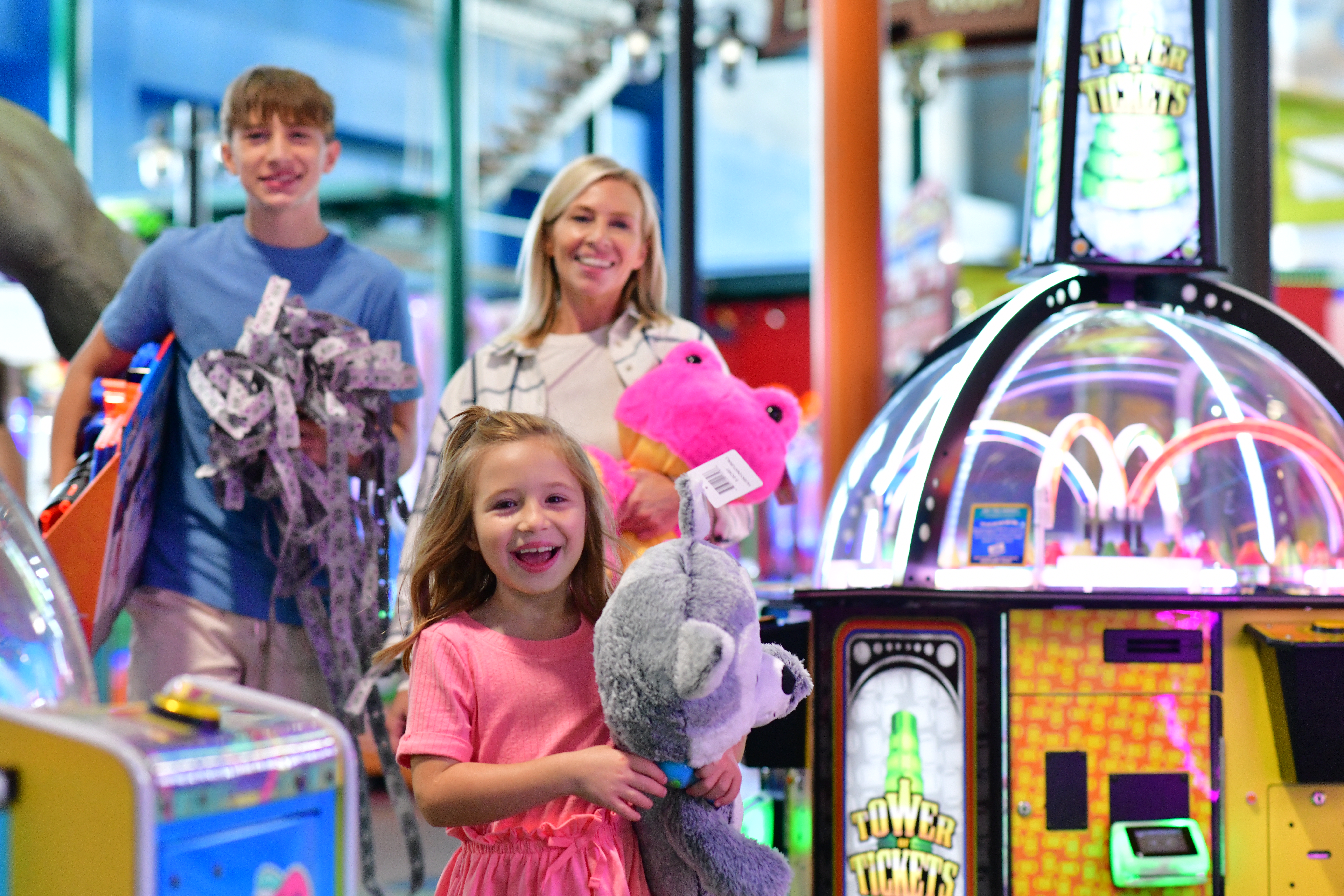 Family in Arcade with prizes in hand