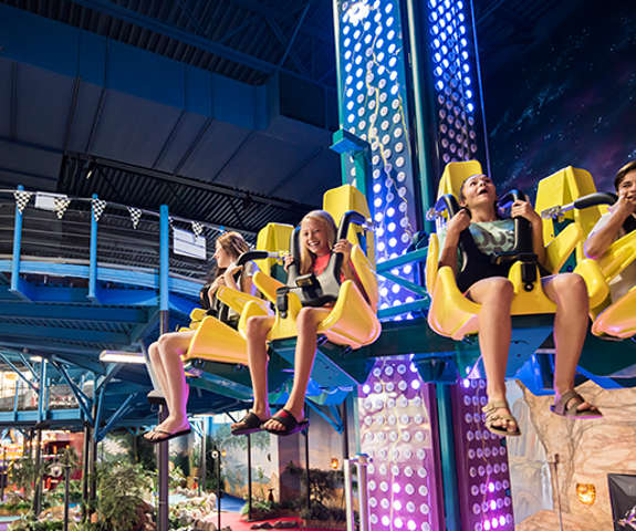 a bunch of kids riding a run ride at Tom Foolerys Adventure Park
