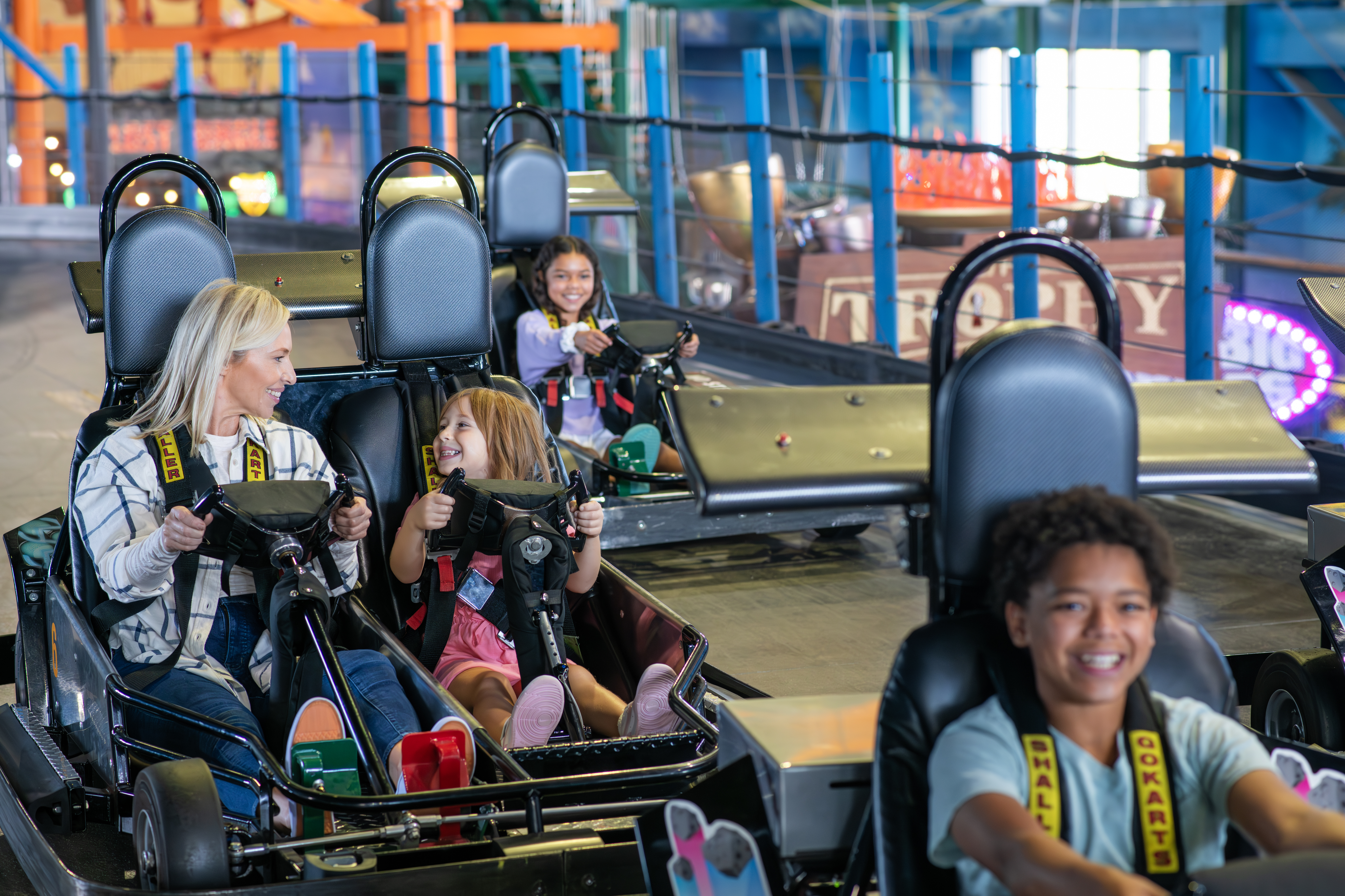 Mom and daughter driving in a go kart