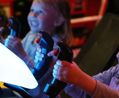 little girls playing a video game in the arcade