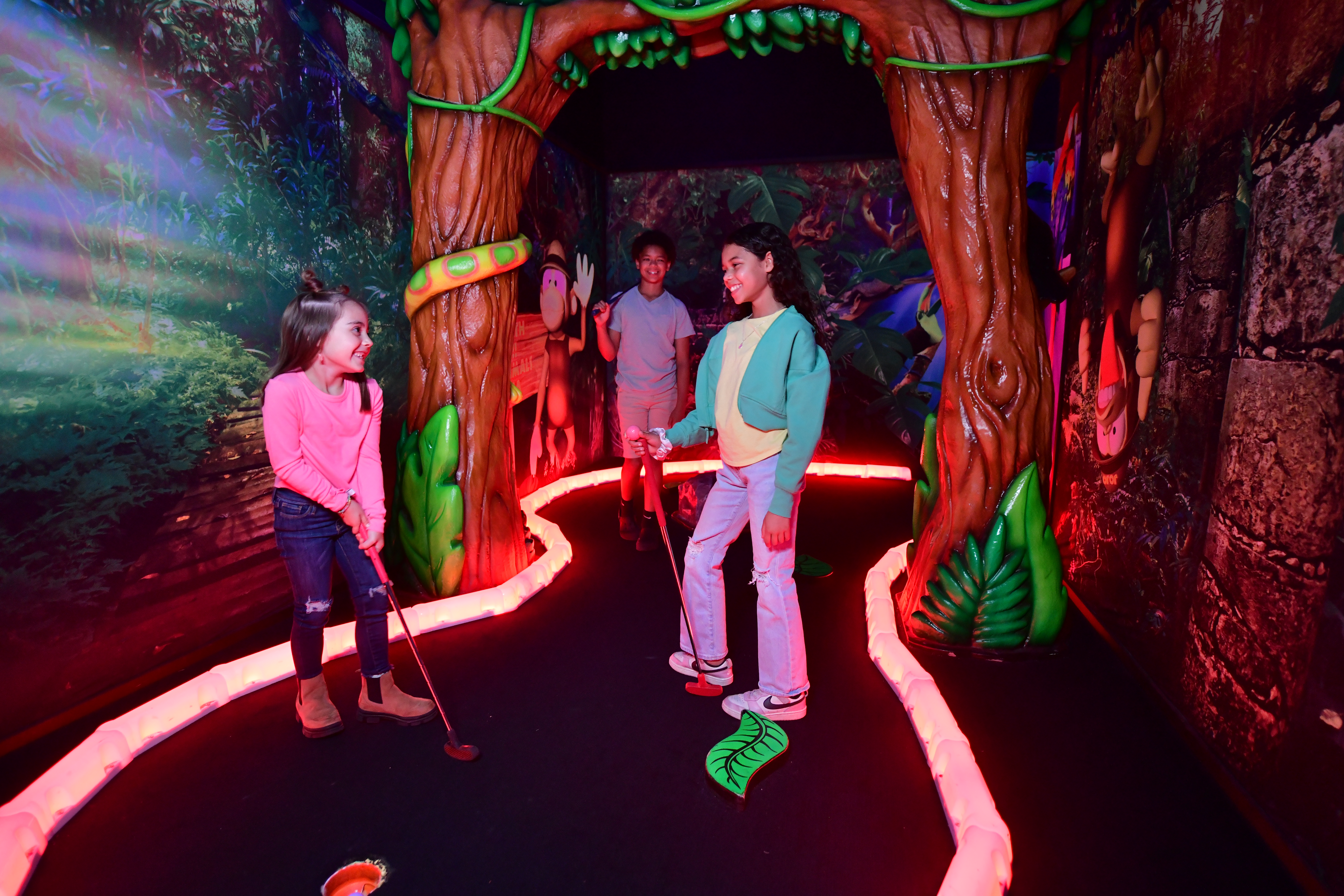 Kids playing glow mini golf