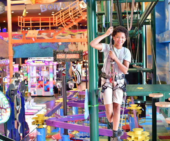 Boy conquering the ropes course