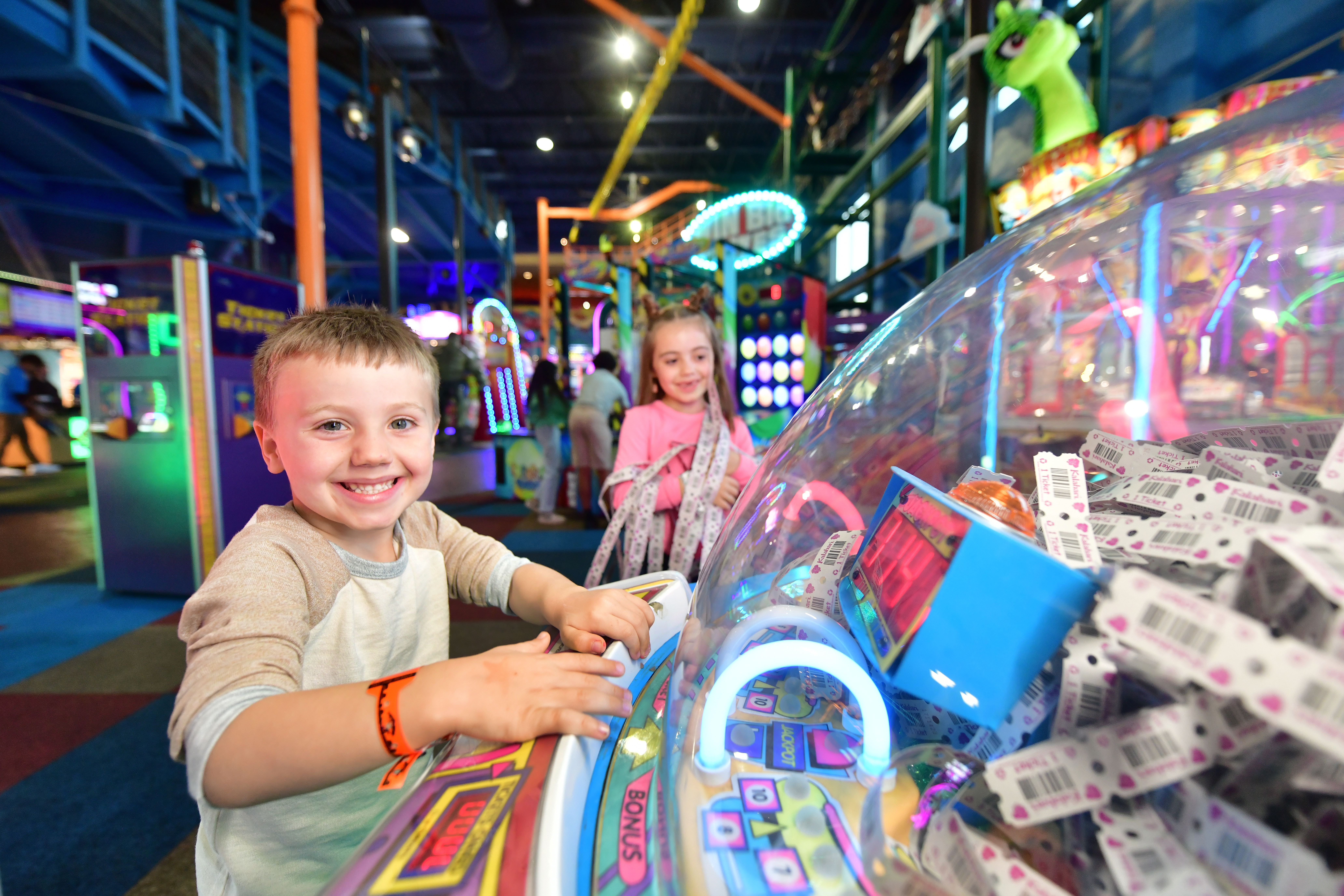 boy and girl playing in the arcade