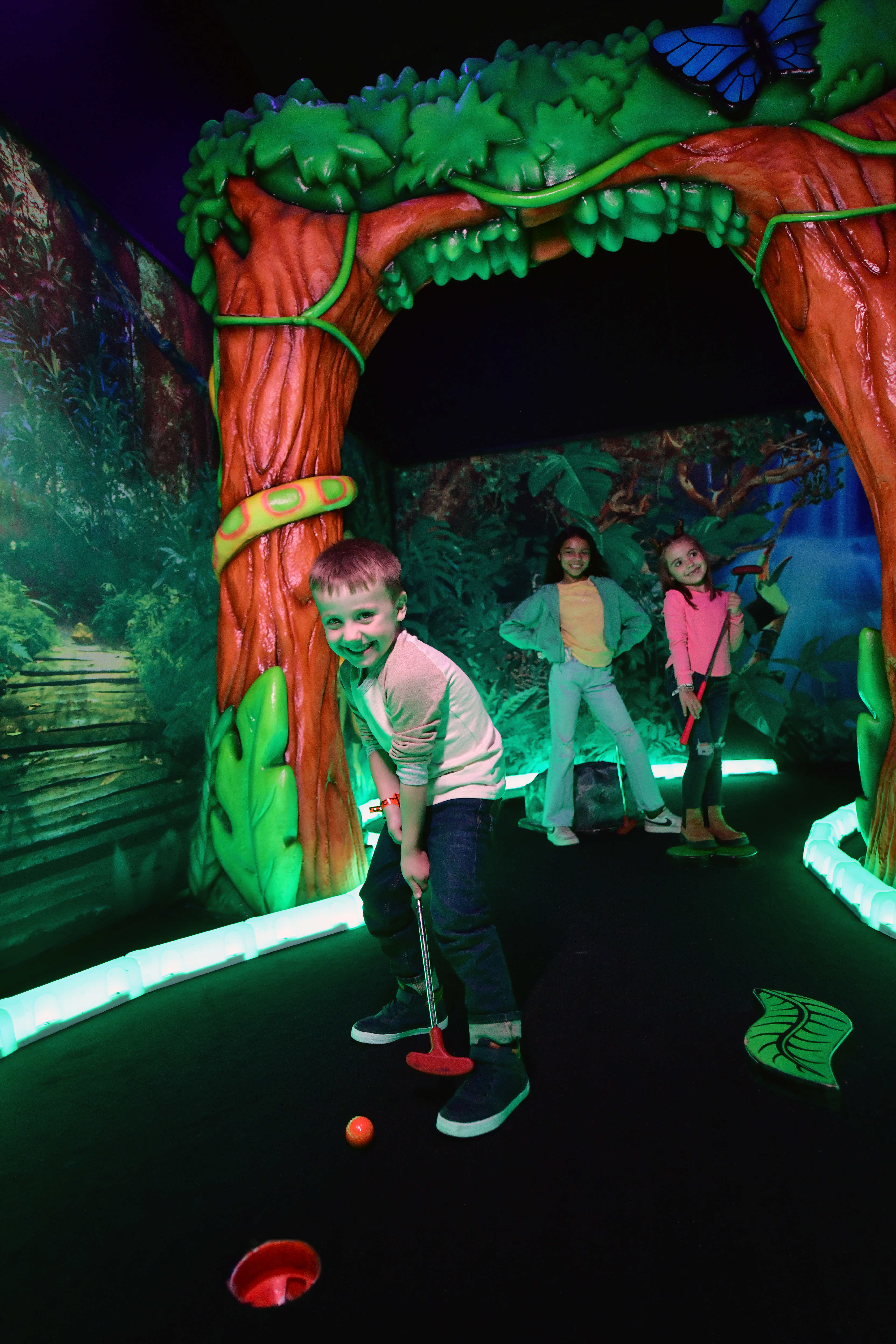 Kids playing mini golf